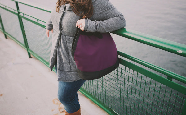 A person on a ferry carrying the Swift over their shoulder.
